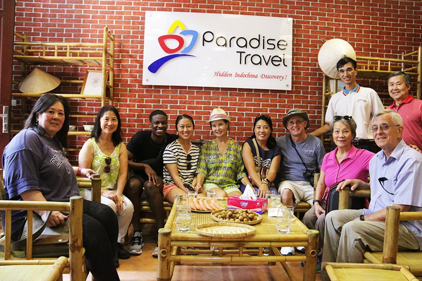 We customize your own your - Alex and a family group at Paradise Travel's office
