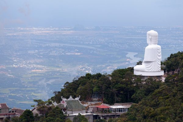Giant Buddha statue on Ba Na Hills facing Da Nang city below