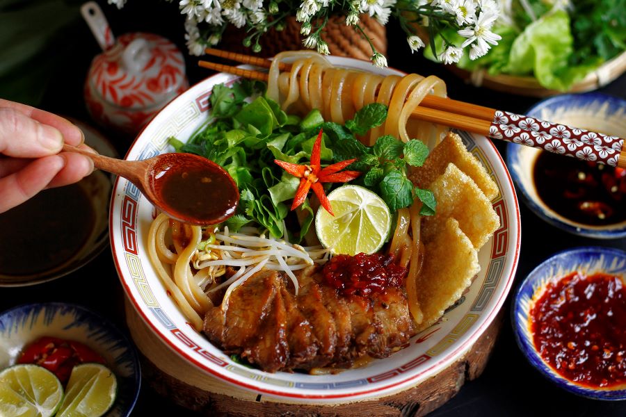 Cooking class in Hoi An teaches authentic Cao Lau, full of history.