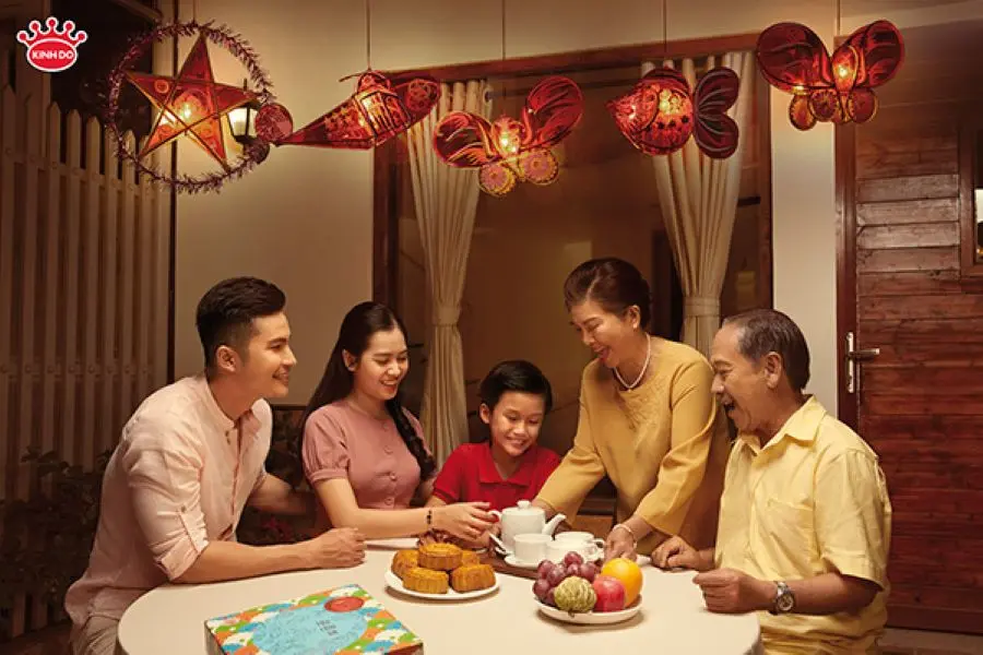 A joyful family celebrates the Mid-Autumn Festival with mooncakes, lanterns, and heartfelt togetherness across generations