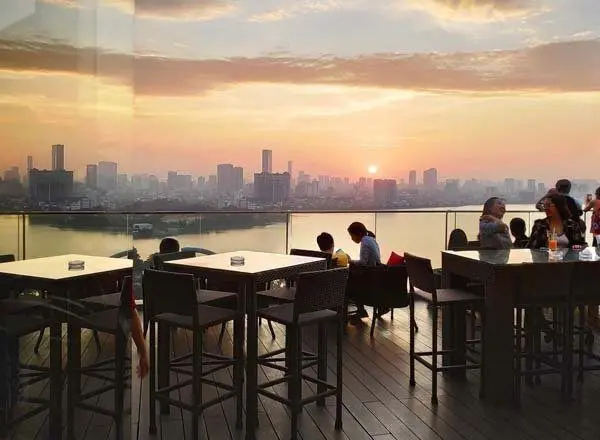 The terrace of The Summit Bar is a place not to be missed in Hanoi to observe a stunning sunset
