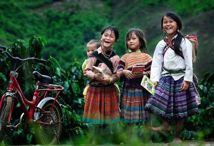 Thai village paths fill with laughter as Ethnic Thai People children head to school.